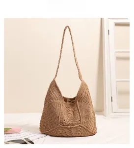 Detail of light brown crochet shoulder bag showing geometric knit texture and inner lining