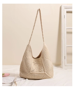 Detailed close-up of handmade beige woven hobo bag with intricate floral crochet pattern