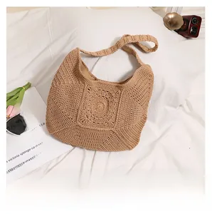 Detailed view of the woven geometric spiral texture on this beige crochet shoulder bag