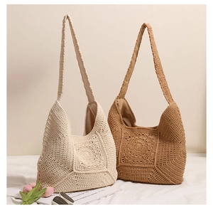 Detailed close-up of handmade crochet shoulder bags in beige and brown with floral pattern