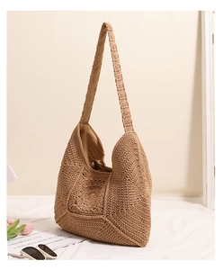 Detailed side view of khaki crochet straw bag with hollow flower knit pattern