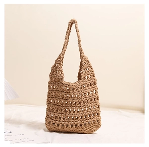 Macro detail of beige hand-woven cotton thread beach bag with minimalist hollow texture