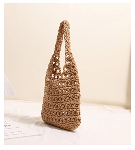 Detail of hollow woven cotton thread texture and soft earthly tone material on a beach bag