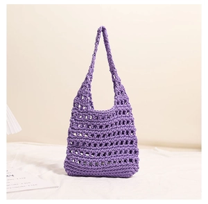 Close-up of purple hand-woven crochet shoulder bag with hollow mesh texture details