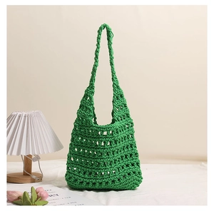 Close-up of bright green crochet knit mesh bag with woven rope texture on white surface