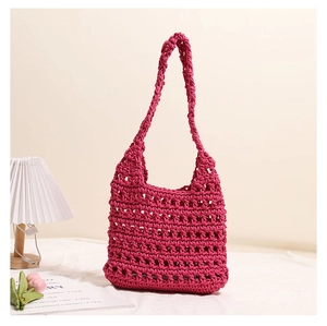 Detailed view of handmade hollow crochet knit tote bag in rose pink cotton rope