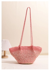 Close-up of pink gradient woven straw tote showing fine handmade crochet texture