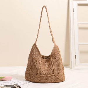 Brown crochet shoulder bag with circular woven pattern for beach vacation styling
