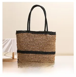 Spacious woven straw tote bag with black stripes and circular handles for summer beach use