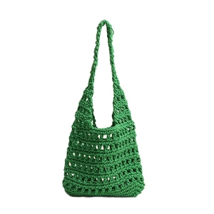Green handmade crochet tote bag featuring a spacious hollow woven design for beach vacations