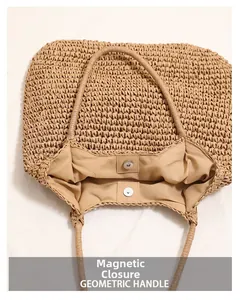 Detail view of large straw tote bag featuring magnetic closure and woven interior lining