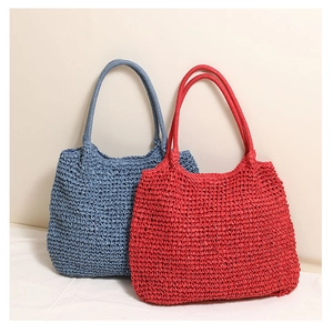 Detailed texture of hand-woven straw tote bags in navy blue and vibrant red colors