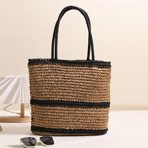 Straw shoulder bag with black stripes and round handles for summer beach vacations