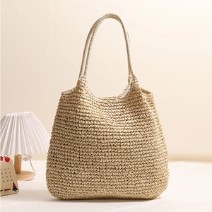 Large beige woven straw tote bag with long handles for bohemian summer beach vacations