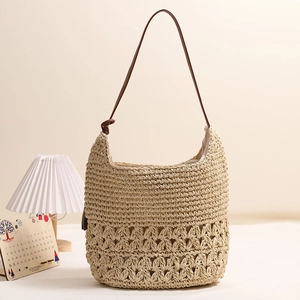 Straw shoulder bag with hollow floral pattern, dark brown strap and inner lining