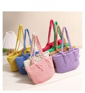 Detail of woven cotton shoulder bags showing diverse vibrant colors and tight crochet texture