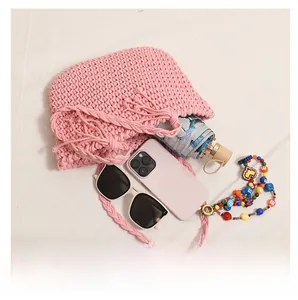 Pink woven shoulder bag showing large interior capacity for sunglasses and umbrella
