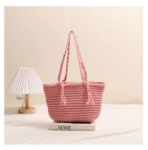 Close-up of pink cotton woven bag showing intricate honeycomb texture and sturdy handles