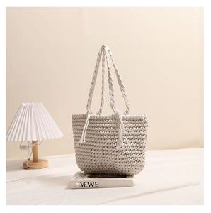 Close-up of handmade cream cotton woven tote bag with thick braided texture and long handles
