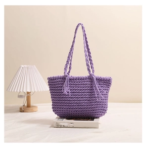Close-up of purple woven cotton shoulder bag with honeycomb texture and tassel detail