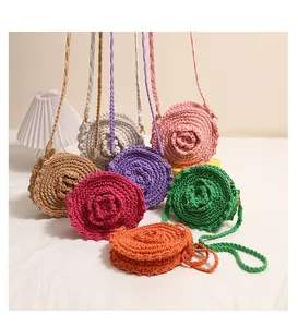 Detail view of colorful handmade crochet round crossbody bags with 3D flower designs