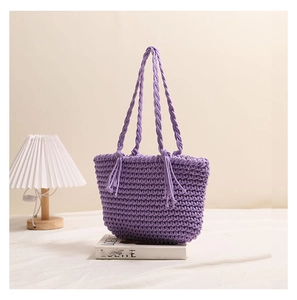 Detailed texture of purple crochet shoulder bag with stylish tassels and woven knots