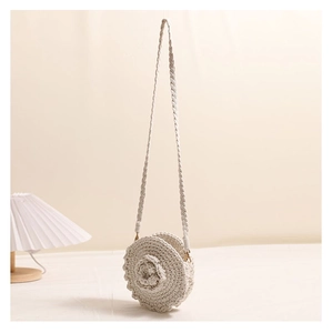 Detailed macro view of 3D spiral flower texture on a handmade crochet crossbody bag