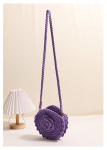 Detailed close-up of a purple handmade crochet round bag with 3D floral rose design