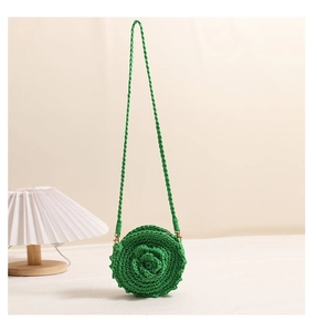 Detailed close-up of a green round crochet bag with a 3D floral rose design pattern
