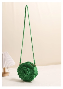 Detail of green handmade crochet shoulder bag featuring 3D rose flower weave and strap