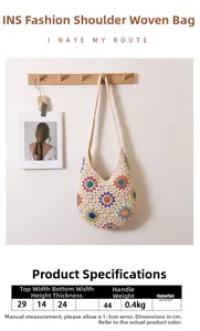Detailed view of handmade woven bag with colorful floral embroidery on cotton shoulder strap