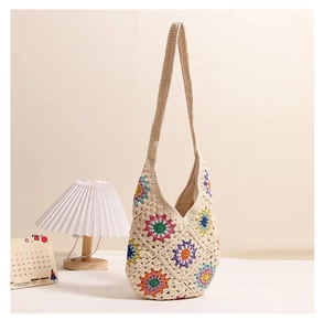 Close-up of bohemian crochet shoulder bag featuring colorful floral knit patterns