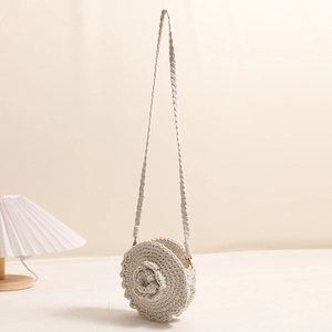 Handmade cream woven round crossbody bag with 3D floral accent and shoulder strap