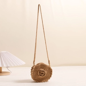 Handmade round crochet crossbody bag with floral detail for summer beach vacation
