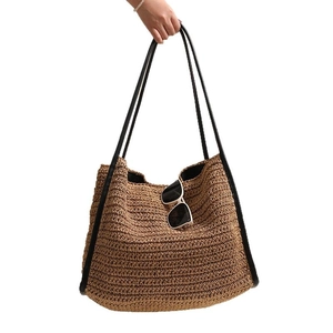 Grande borsa tote in paglia con manici in pelle nera e occhiali per vacanze estive