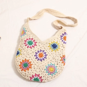 Bohemian crochet shoulder bag with colorful floral patterns on beige woven cotton fabric
