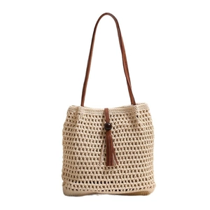 Beige woven shoulder bag with leather straps, fringe tassels, and wooden bead detail