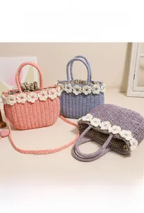 Detail of woven straw bags with crochet flowers, polka dot lining and braided straps