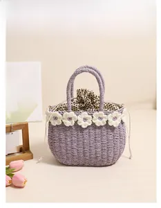 Detailed view of purple straw woven bag with white crochet flowers and polka dot lining