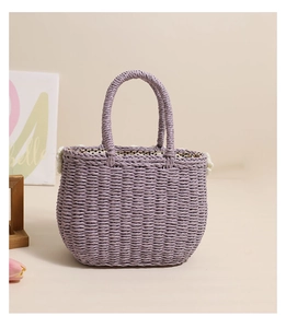 Close-up of lavender woven straw bag with floral accents and polka dot lining