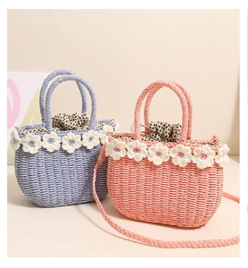 Detail of straw bags with crochet flower decor and polka dot drawstring lining