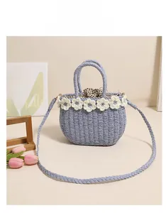Detailed view of blue straw bucket bag with floral trim and polka dot lining
