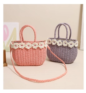 Close-up of handmade straw bags with floral crochet trim and polka dot lining details