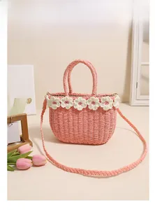 Pink straw bag detail with white floral crochet and matching woven shoulder strap