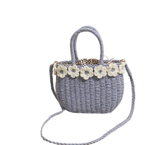 Floral straw crossbody bag with white crochet flowers and polka dot drawstring lining