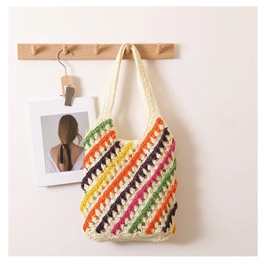 Detail of colorful striped crochet tote bag with hollow knit texture on a wooden hook