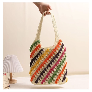 Detail of colorful zigzag striped crochet patterns on a handmade straw woven tote bag