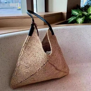 Large raffia triangle straw tote bag with black leather straps for summer beach vacations