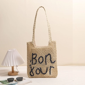 Straw tote bag with Bon jour embroidery and long handles for beach vacations
