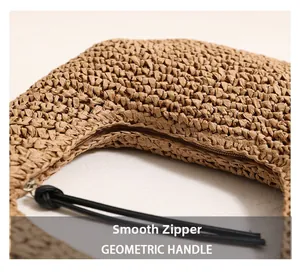 Detail of smooth zipper closure with long tassel on woven straw beach tote handbag